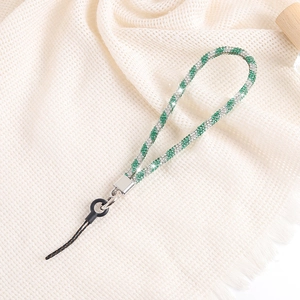 Detail of green and silver rhinestone woven phone lanyard with silver metal clasp