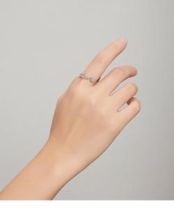 Close-up of three shimmering zircon butterflies on a silver ring worn by a model