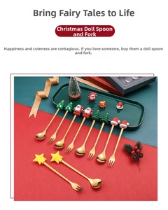 Detail of Christmas dessert spoons and forks with festive silicone figurines on gold plating