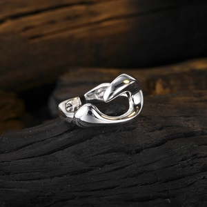 Polished silver liquid metal ring with geometric sculptural design and open band