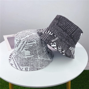 Détail du chapeau bob en coton avec imprimé journal et motif de texte monochrome