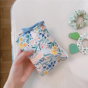 Close-up of a floral cotton mini pouch with a zipper tassel and a cute rabbit pattern