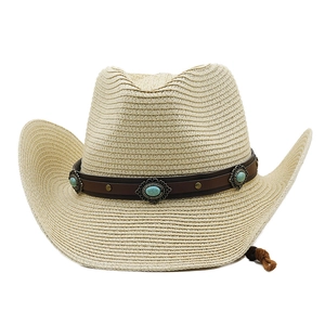 Close-up of leather hat band with turquoise stones and metal studs on a straw cowboy hat