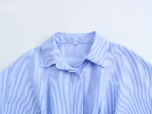 Detailed close-up of light blue vertical stripe shirt collar and lapel design