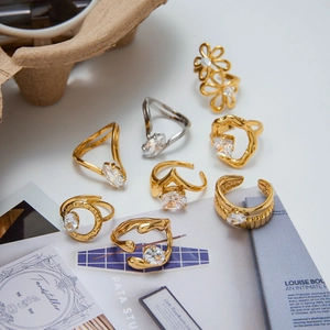Detailed view of high-end gold and silver zircon rings in elegant floral and organic designs