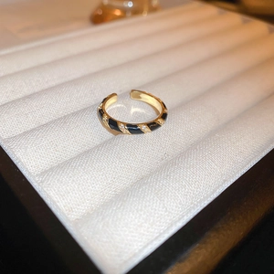 Detailed view of gold-plated dragon ring with black enamel stripes and zircon accents