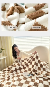 Detail of soft brown checkerboard plush blanket showing fluffy texture and cozy home scene