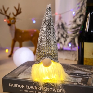 Detail of glowing Christmas gnome with silver sequins and warm LED beard decoration