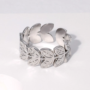 Close-up of silver leaf pattern titanium steel ring with adjustable open design
