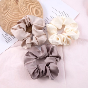 Three large satin silk scrunchies in champagne, white and dusty rose colors