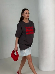 Detail of oversized dark grey cotton T-shirt with bold red graphic letter printing