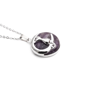 Detail of silver cat on moon pendant featuring a round purple crystal stone and O-chain