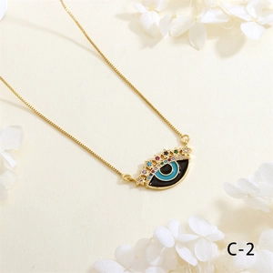 Detail of gold evil eye necklace with colorful zircon stones on textured background