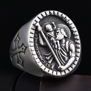 Macro shot of St. Christopher religious relief and cross emblem on vintage silver ring