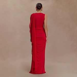 Detail of red backless evening gown featuring elegant draped mesh pleats and open back