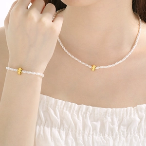 Elegant 2-piece set of white pearl necklace and bracelet with gold girl pendant charms