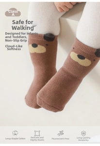 Detail of baby walking sock with bear pattern and non-slip silicone grip on the sole
