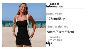 Detail of a black sporty tankini featuring criss-cross pleats and white side stitching