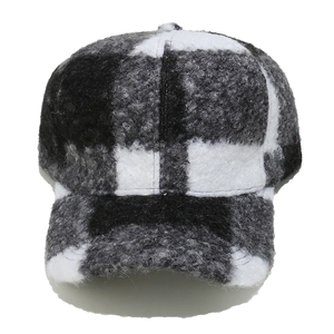 Detailed view of winter baseball cap featuring plaid sherpa fabric and warm texture