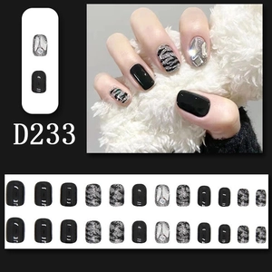Detail view of D233 long coffin press-on nails with black, zebra print and rhinestone gems
