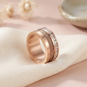 Macro shot of rose gold ring with Roman numerals, twisted wire and inlaid zircons