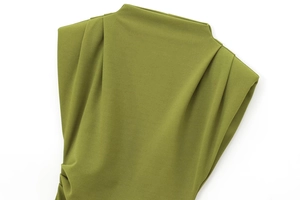 Detailed view of olive green ruched fabric and shoulder pleats on a mock neck dress