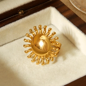 Detail view of 18k gold sunflower ring with sunburst texture in a luxury jewelry box