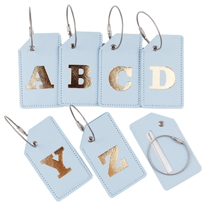 Light blue PU leather luggage tags with gold initials and steel loops on white background