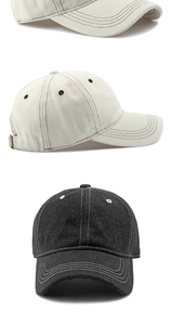 Detail of cream and black baseball caps showing denim texture and contrast stitching