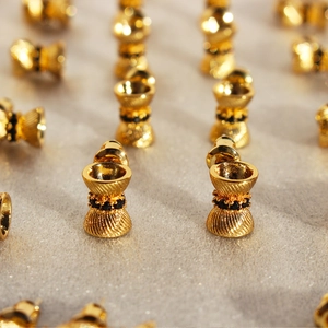 Creative hourglass spiral gold earrings with black zircon stones in a sleek metallic finish