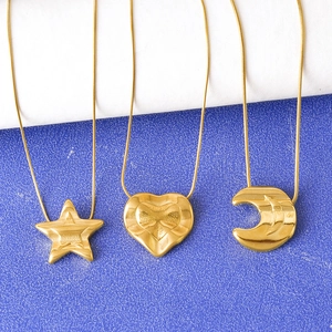 Three gold titanium steel necklaces with star heart and crescent moon charms on snake chains