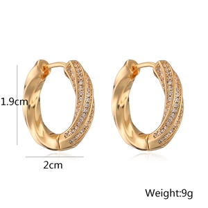 Detail view of twisted gold hoop earrings with pavé zircons and size measurements