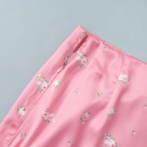 Detailed macro view of invisible side zipper on pink floral satin maxi skirt
