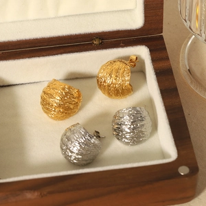 Geometric C-shaped brushed titanium steel earrings in gold and silver with lava texture