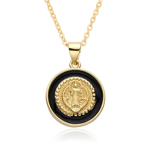 Close-up of gold and black religious medallion necklace with Virgin Mary relief detail