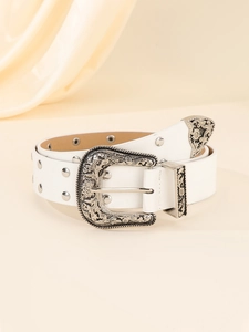 Close-up of white leather belt with silver studs and embossed western floral buckle