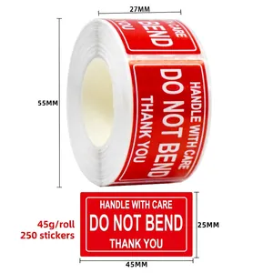 Macro detail of red fragile warning stickers roll with Do Not Bend text and handle with care