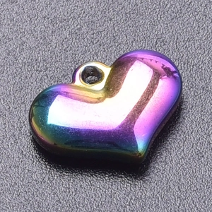 Macro view of a heart pendant featuring iridescent gradient vacuum plating and a top loop