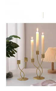 Detail of matte gold iron candle holder with modern twisted spiral design for tables