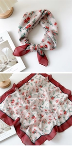 Detail of soft cotton-linen square scarf with red floral prints and contrasting borders