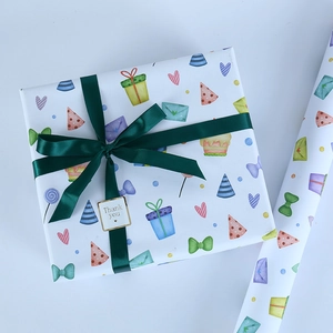 Birthday themed gift wrapping paper set with colorful party icons and green ribbon