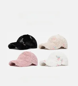 Four colors of plush baseball caps with soft faux fur texture and floral embroidery