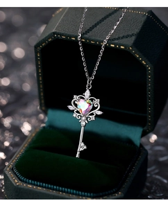 Close-up of S925 silver heart key pendant with zircon in a green velvet jewelry box