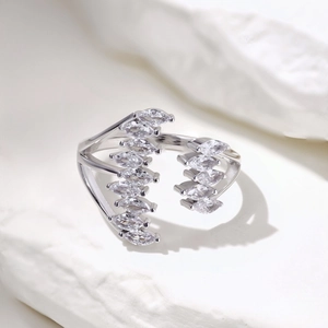 Detail shot of marquise-cut zircons set in a silver leaf-shaped open ring design