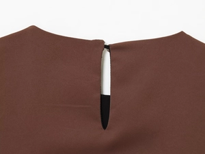 Detail of satin brown blouse back neckline with keyhole opening and button closure