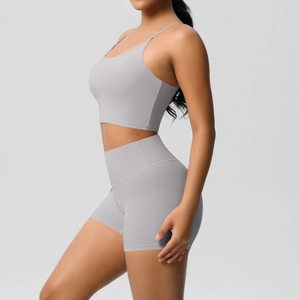 Detailed view of high-waist fitness shorts and thin-strap yoga bra set in light grey