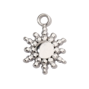 Macro shot of sun-shaped stainless steel pendant with polished silver beads and central disc