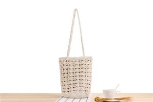 Close-up of beige crochet tote bag with hollow diamond pattern and cotton rope texture