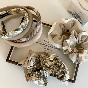 Detailed set of brown plaid bow scrunchies and fabric headbands in coffee tones