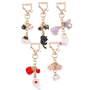 Set of five colorful cartoon cat and paw metal keychains with enamel heart charms